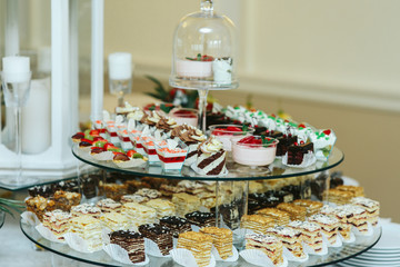 Cold and baked desserts stand served on glass dish
