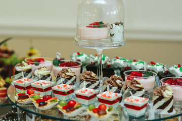 Cold desserts in glasses served on the large dish