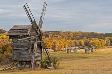 Fototapeta na wymiar Old wooden windmill in the countryside in autumn season