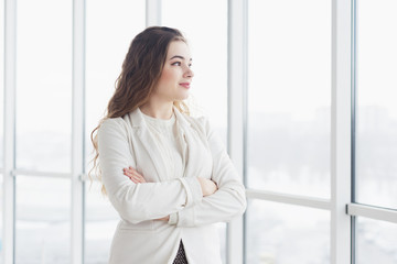 beautiful young business woman by window