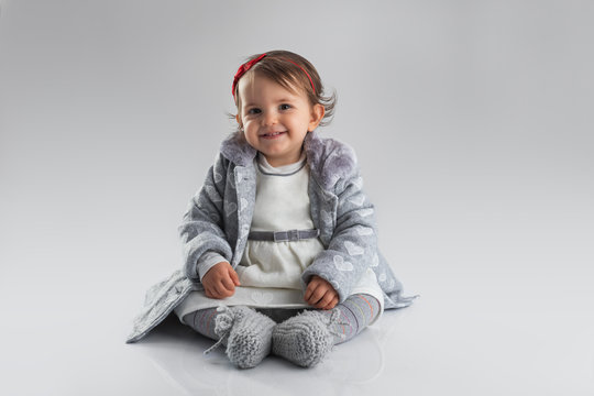 Adorable baby girl portrait on grey background