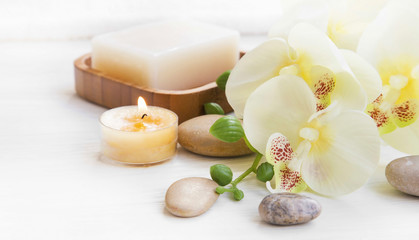 Fototapeta na wymiar Spa set with orchid, candle and massage stones