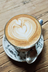 Latte art on wooden table