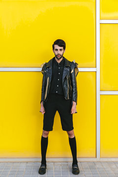 Trendy man over a yellow wall