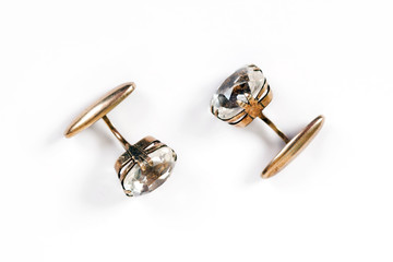 Ancient gold men's cuff links with rock crystal are isolated on a white background - obrazy, fototapety, plakaty
