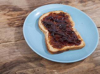 Typical Dutch apple syrup called Appelstroop on bread on wooden background