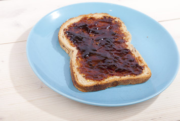 Typical Dutch apple syrup called Appelstroop on bread on wooden background