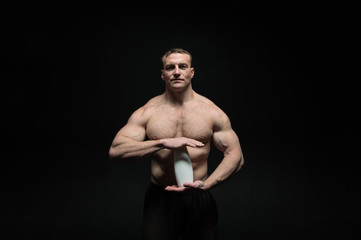 handsome sexy athlete man with muscular body holds drink bottle