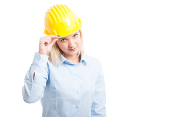 Attractive woman engineer holding her yellow helmet