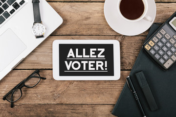 Naklejka premium Allez Voter, French Go Vote text on tablet computer
