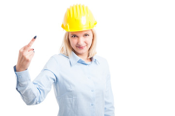 Female engineer wearing helmet showing obscene gesture