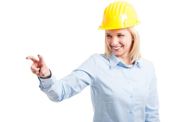 Female engineer wearing helmet using touchscreen