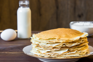 fresh homemade stack of crepes with ingredients