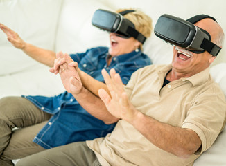 Obraz na płótnie Canvas Senior mature couple having fun with virtual reality glasses