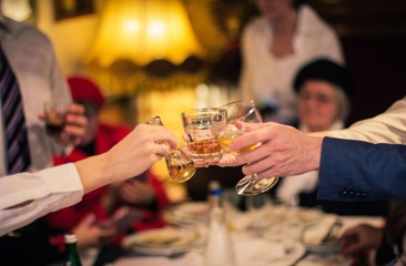 People making toast with alcohol drinks