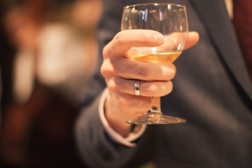 Man holding wine glass making toast