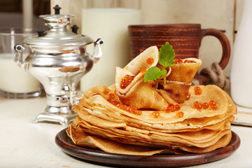 Pancakes with red caviar. Traditional Russian cuisine. Maslenitsa.