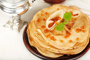 Pancakes with red caviar. Traditional Russian cuisine. Maslenitsa.