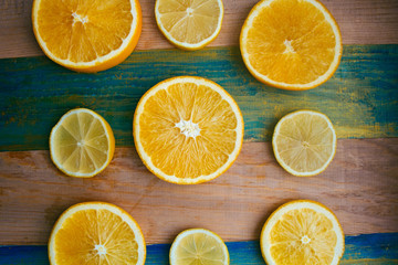 Naklejka na ściany i meble slices of lemon and orange on a wooden table