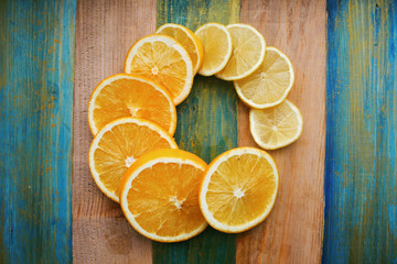 slices of lemon and orange on a wooden table