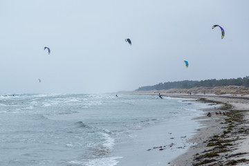 Kitesurfing vid en blåsig sandstrand