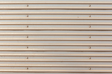 Obraz premium The rustic corrugated grey metal garage door.