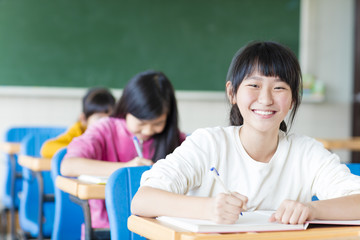 happy teenager girl learning in the classroom