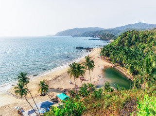 Obraz premium Ocean Beach in summer sunlight. Goa, India. Vivid, splittoned image. 