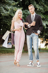 portrait of a beautiful couple walking in the street in summer