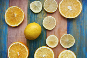 Naklejka na ściany i meble slices of lemon and orange on a wooden table