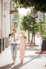 portrait of a beautiful couple walking in the street in summer