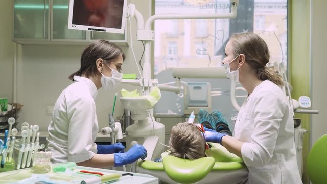 Dentists treat tooth boy. 4k footage.
Dental clinic. Close-up.