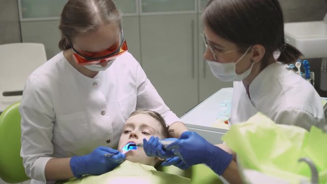 Dentists treat tooth boy. 4k footage.
Dental clinic. Close-up.