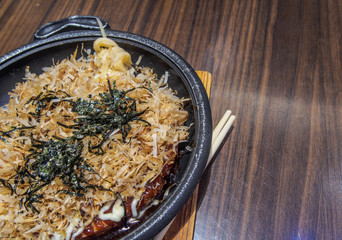 japanese pizza (okonomiyaki) on the wooden table