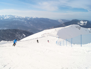 People skiing in the mountains.