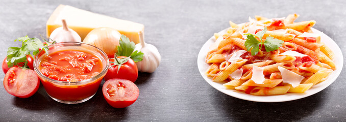 plate of penne pasta with tomato sauce and parmesan