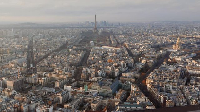 Elevated view of the Eiffel Tower, city skyline and La Defence skyscraper district in the distance, Paris, France - timelapse