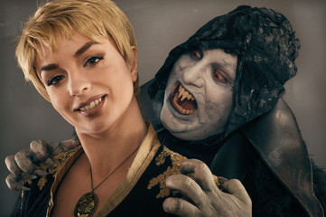 Ancient monster vampire demon bites a woman neck. Halloween fant