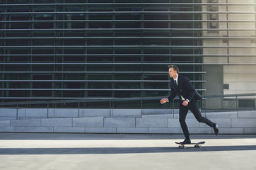 Fototapeta na wymiar Businessman pushing his skateboard with purpose