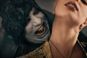 Ancient monster vampire demon bites a woman neck. Halloween fant