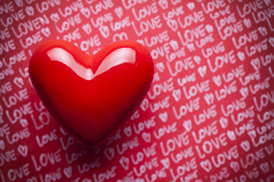Red heart on paper background