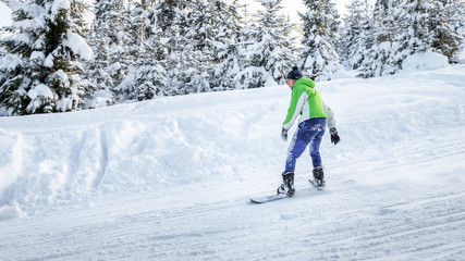 snowboarder rides a snowboard at the ski slope