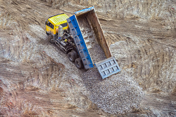 truck unloads rubble breakstone to the ground