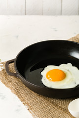 Morning in the kitchen. Cooking breakfast. Fried egg.