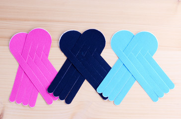 Special physio tape rolls on wooden background, closeup.