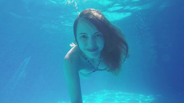 Girl Is Swimming Underwater