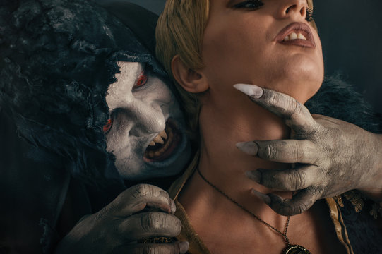 Scary vampire devil biting young woman. Medieval gothic nightmar