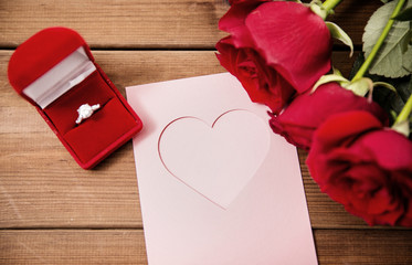 close up of diamond ring, roses and greeting card