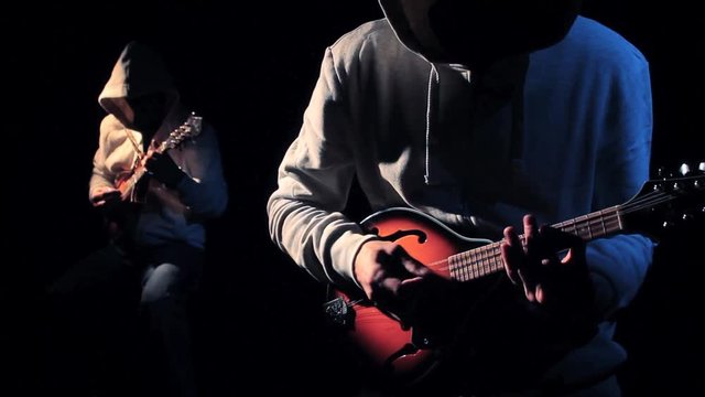 Anonymous Hooded Musicians Playing Mandolin