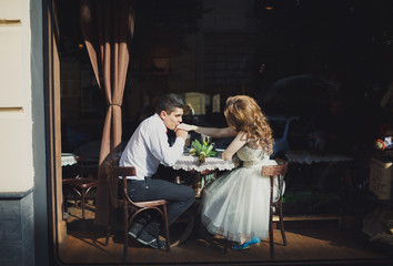 The lovely couple in love sits in restaurant